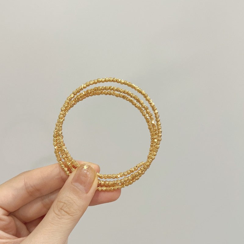 Multi-layered elastic cuff bracelet.