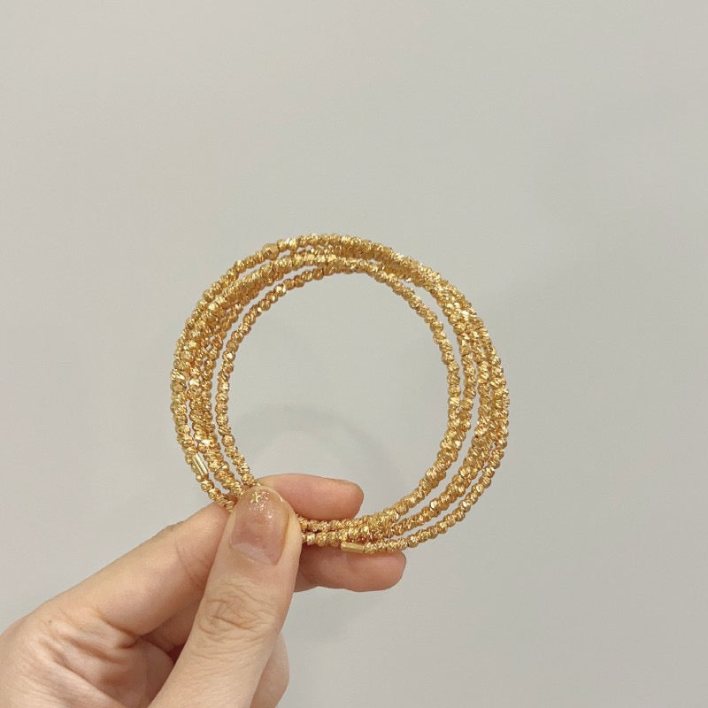 Multi-layered elastic cuff bracelet.